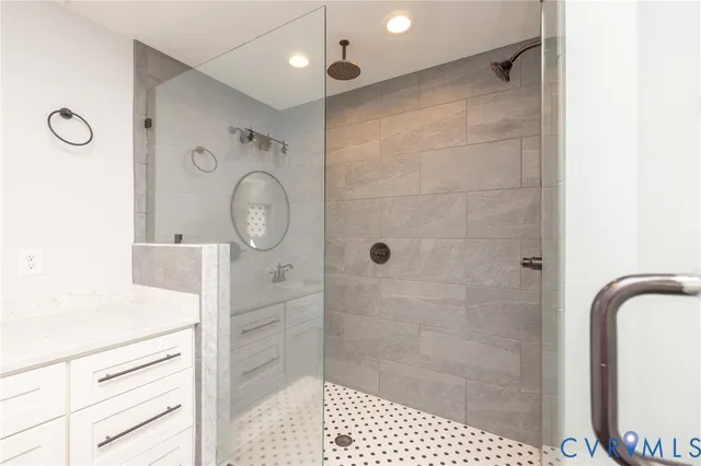 a bathroom with a shower a mirror and a shower