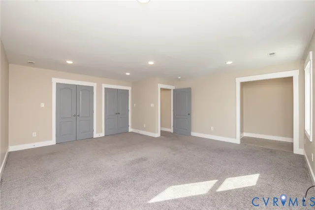 an empty room with closet and a bathroom