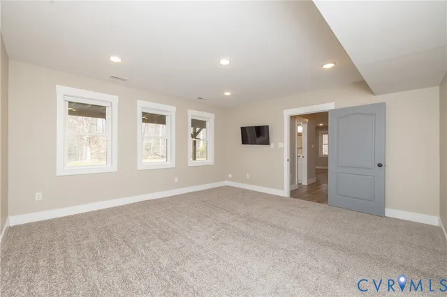 an empty room with windows and closet