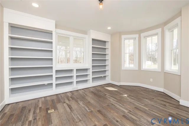 a view of wooden floor and windows in a room