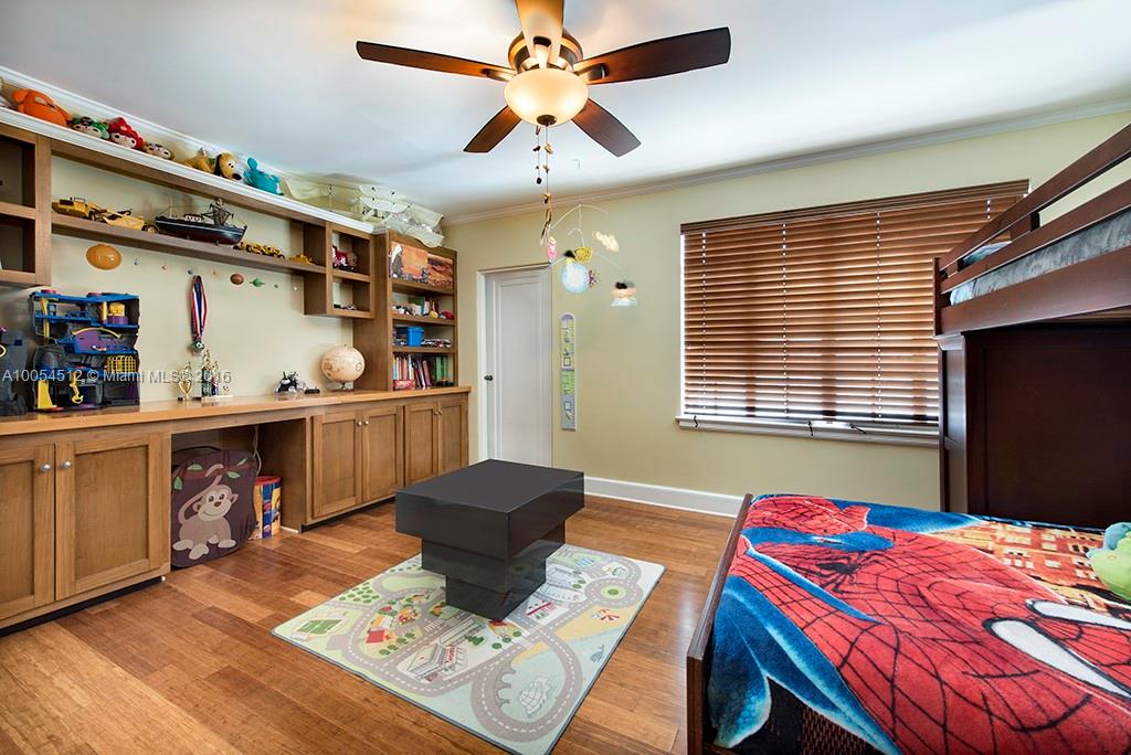 4236 Alton Road Miami Beach, FL 33140 - Photo 12 of 24 a bedroom with a bed and a chandelier