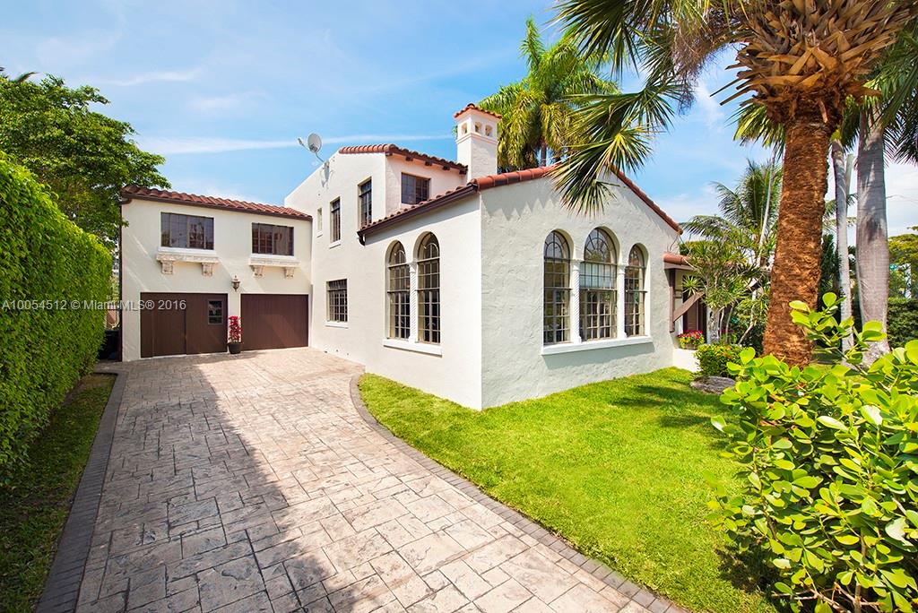 4236 Alton Road Miami Beach, FL 33140 - Photo 2 of 24 a front view of a house with a garden