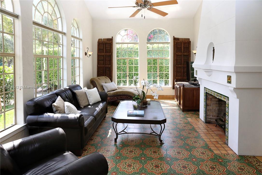 4236 Alton Road Miami Beach, FL 33140 - Photo 23 of 24 a living room with furniture a large window and a fireplace