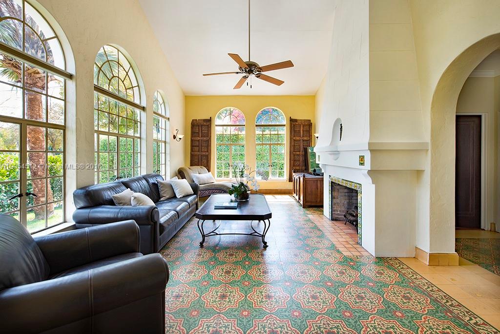 4236 Alton Road Miami Beach, FL 33140 - Photo 4 of 24 a living room with fireplace furniture and a large window