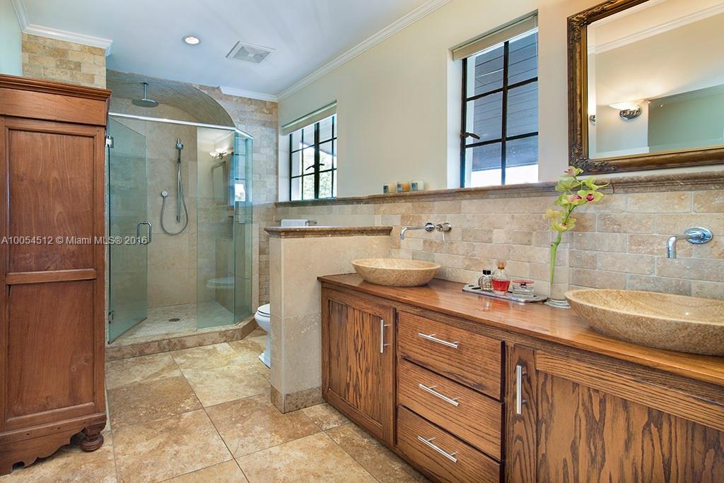 4236 Alton Road Miami Beach, FL 33140 - Photo 10 of 24 a bathroom with a granite countertop sink a toilet and shower