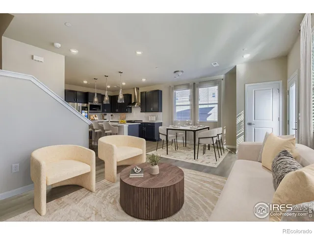 a living room with furniture a fireplace and a kitchen view
