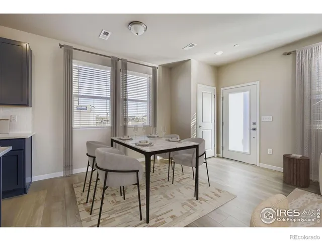 a view of a room with furniture and wooden floor