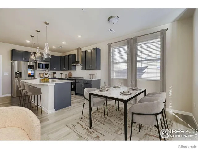 a kitchen with a table and chairs in it
