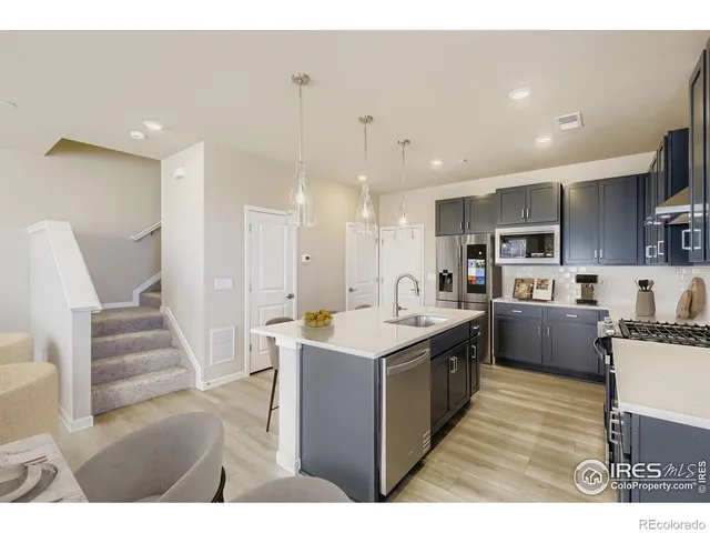 a large kitchen with stainless steel appliances lots of counter top space