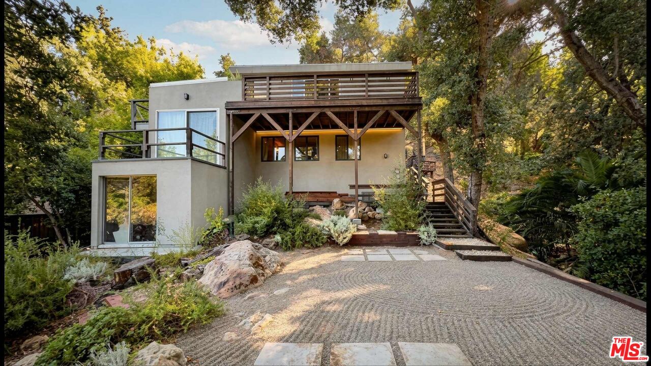 a front view of a house with a garden