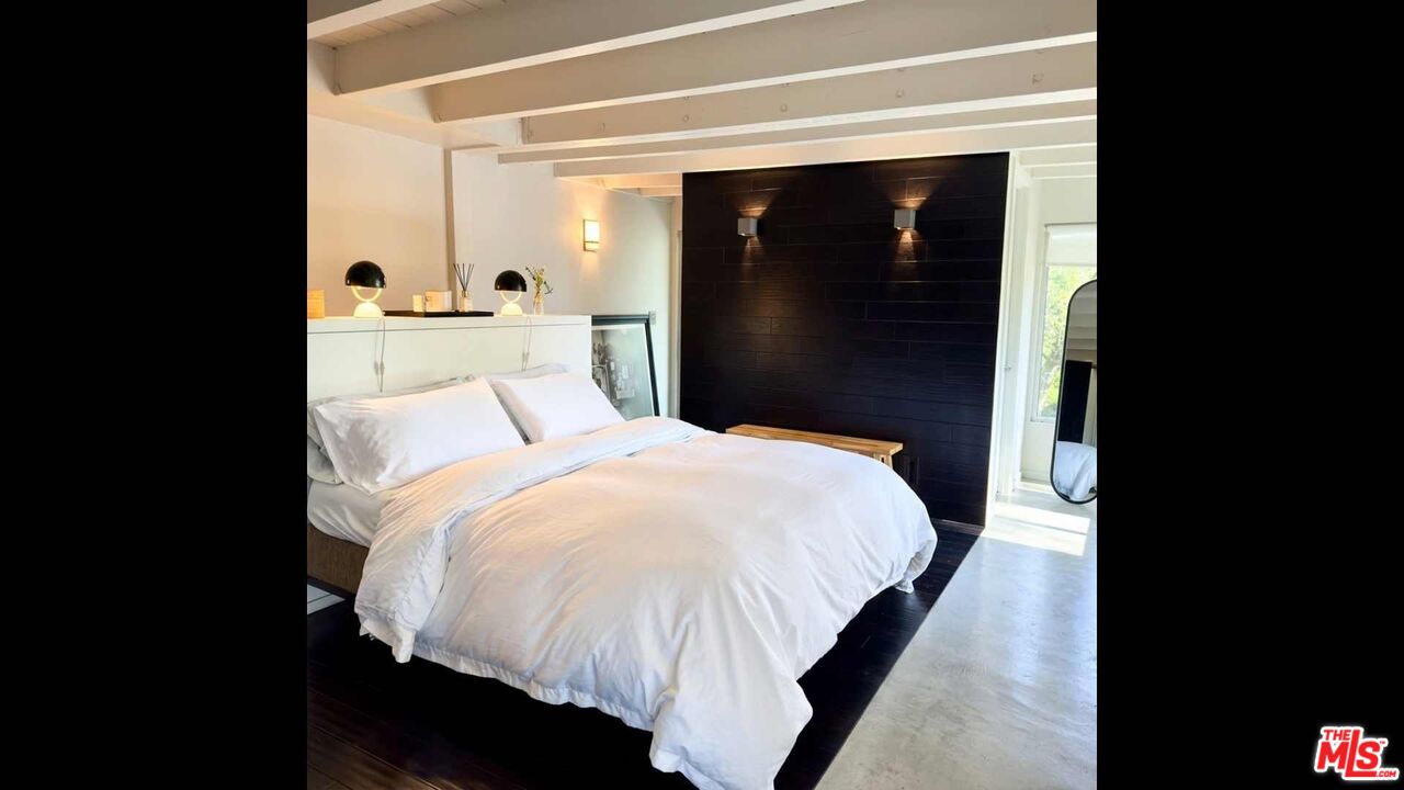 19562 Cave Way Topanga, CA 90290 - Photo 11 of 29 a bed room with a bed and a night stand
