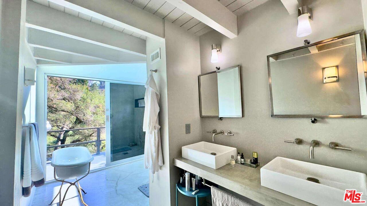 19562 Cave Way Topanga, CA 90290 - Photo 14 of 29 a bathroom with a sink a mirror and a shower