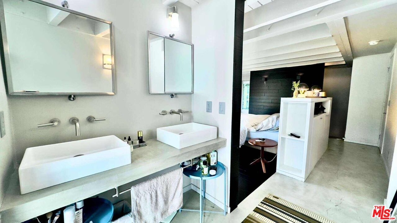 19562 Cave Way Topanga, CA 90290 - Photo 15 of 29 a bathroom with a sink a mirror and shower