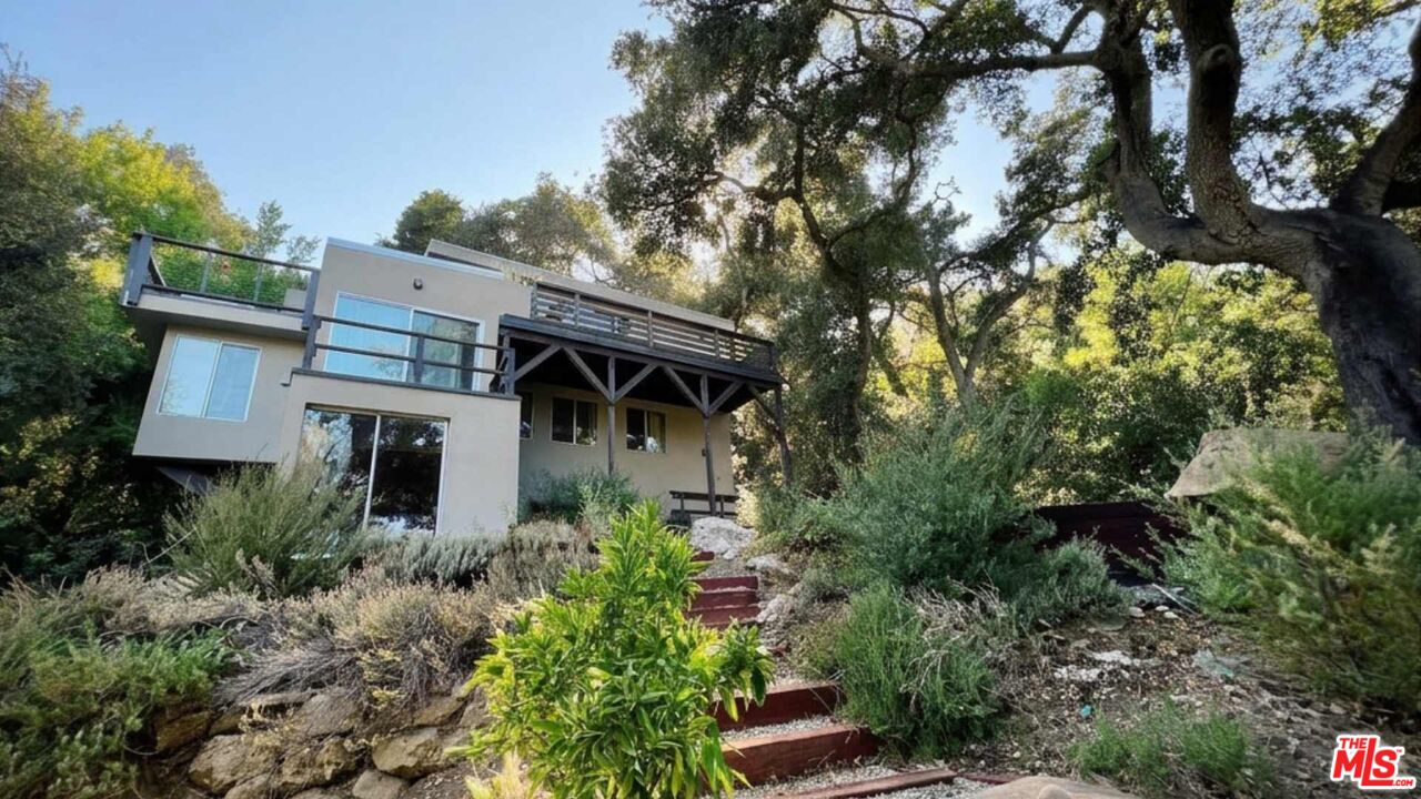 19562 Cave Way Topanga, CA 90290 - Photo 2 of 29 a front view of house with green space
