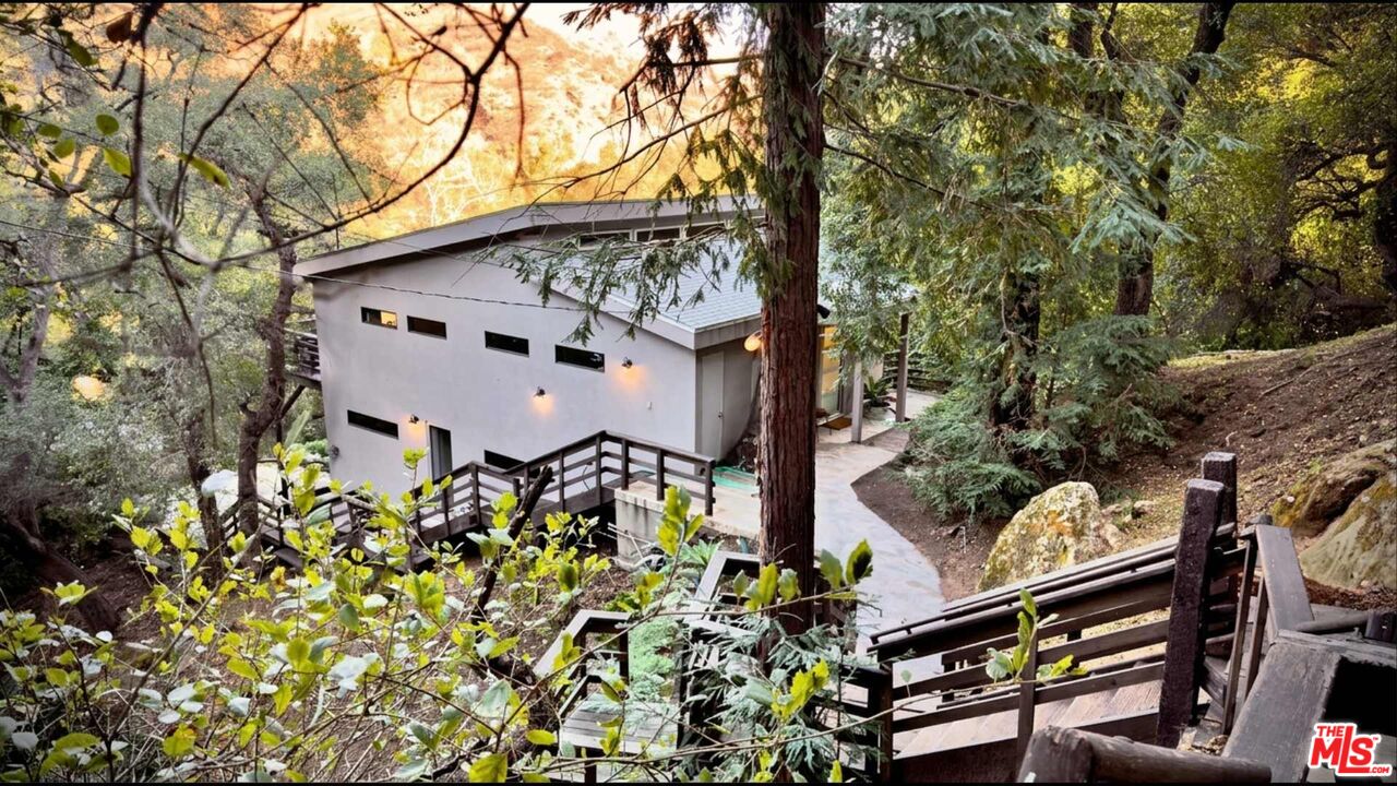 19562 Cave Way Topanga, CA 90290 - Photo 3 of 29 front view of a house with a tree