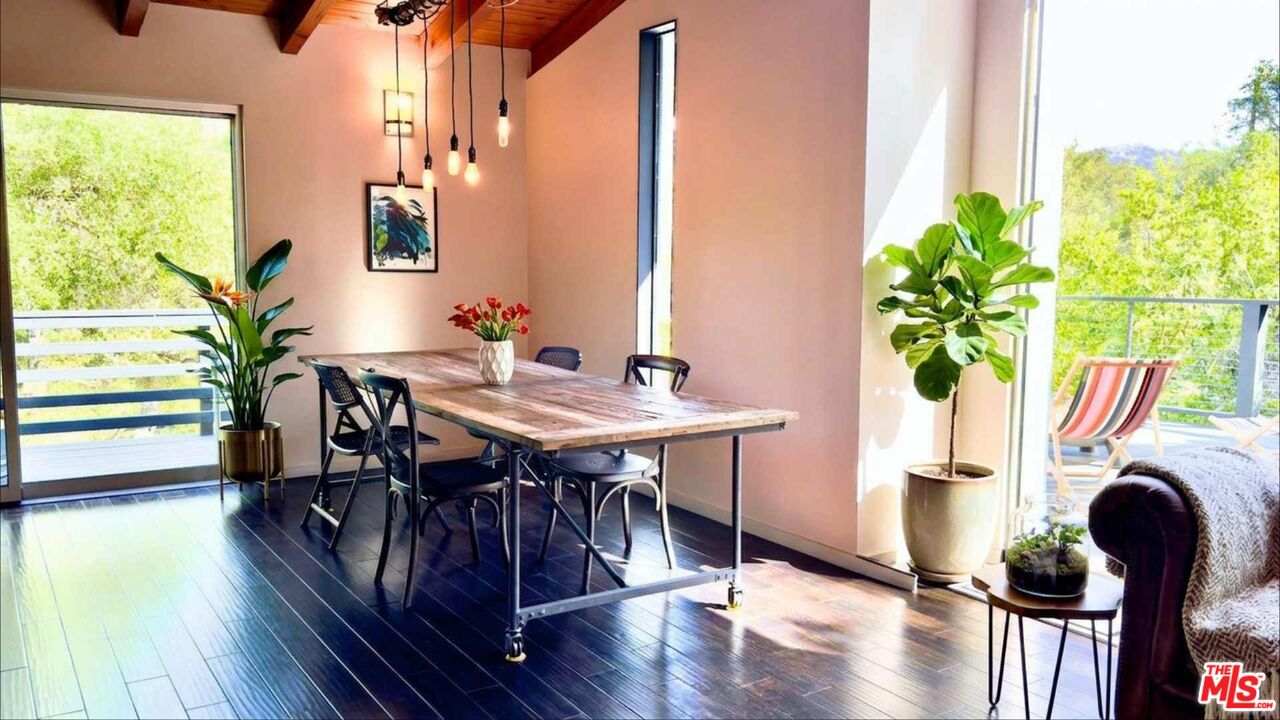 19562 Cave Way Topanga, CA 90290 - Photo 7 of 29 a view of a dining room with furniture window and wooden floor
