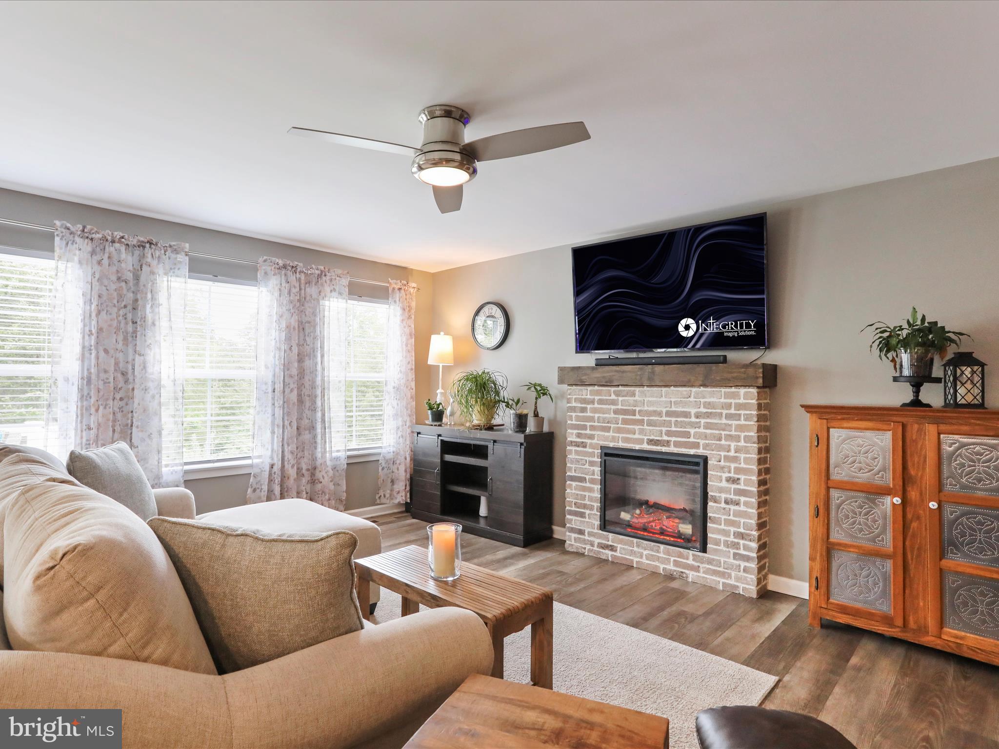 164 Stager Avenue Falling Waters, WV 25419 - Photo 14 of 46 a living room with furniture a flat screen tv and a fireplace