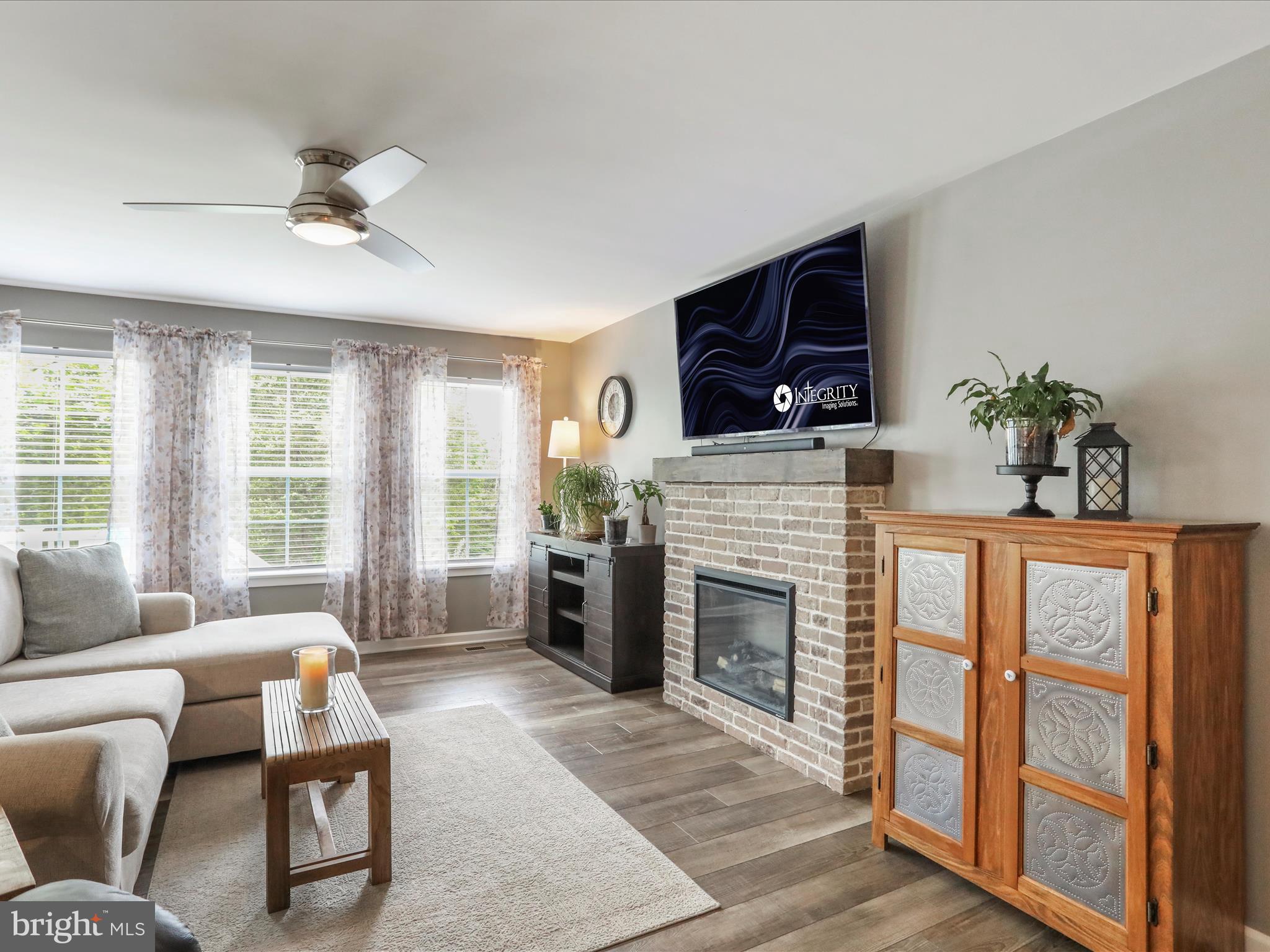 164 Stager Avenue Falling Waters, WV 25419 - Photo 16 of 46 a living room with furniture a fireplace a flat screen tv and a large window