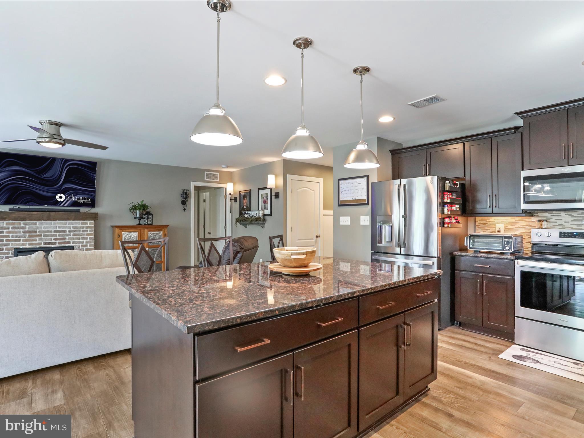 164 Stager Avenue Falling Waters, WV 25419 - Photo 18 of 46 a kitchen with stainless steel appliances granite countertop a sink a stove and a refrigerator