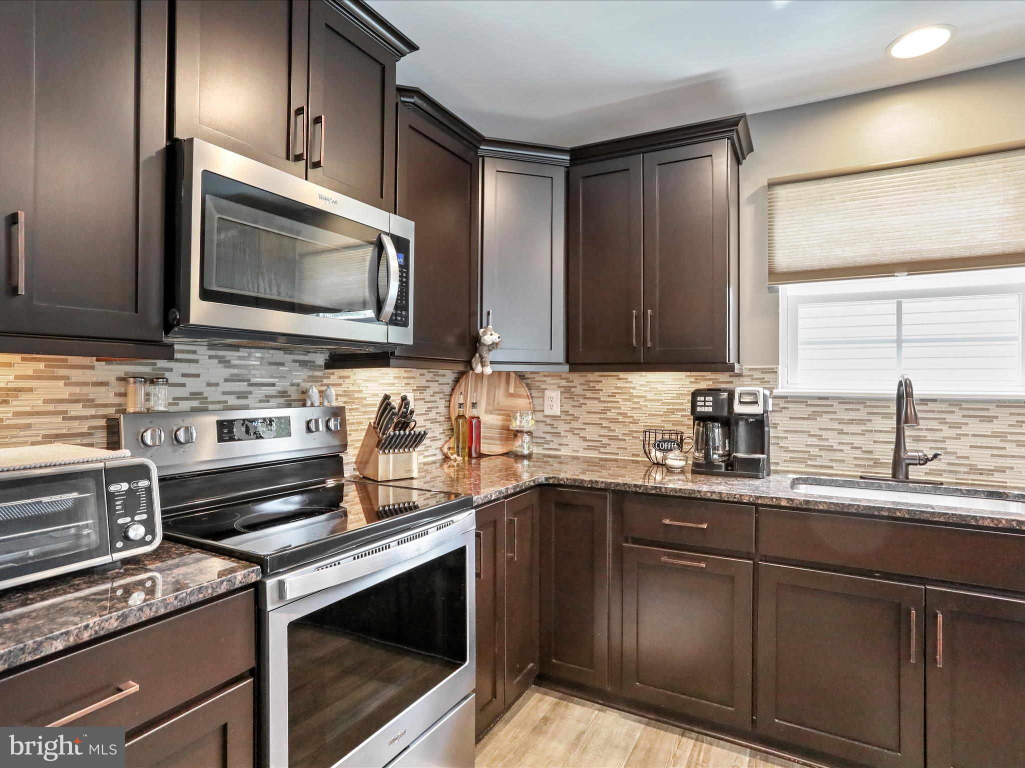 164 Stager Avenue Falling Waters, WV 25419 - Photo 20 of 46 a kitchen with stainless steel appliances granite countertop a sink stove and microwave