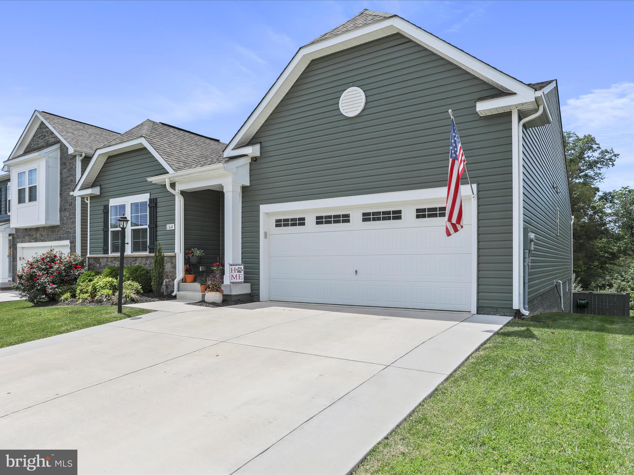 164 Stager Avenue Falling Waters, WV 25419 - Photo 2 of 46 a view of a house with a small yard and a large tree