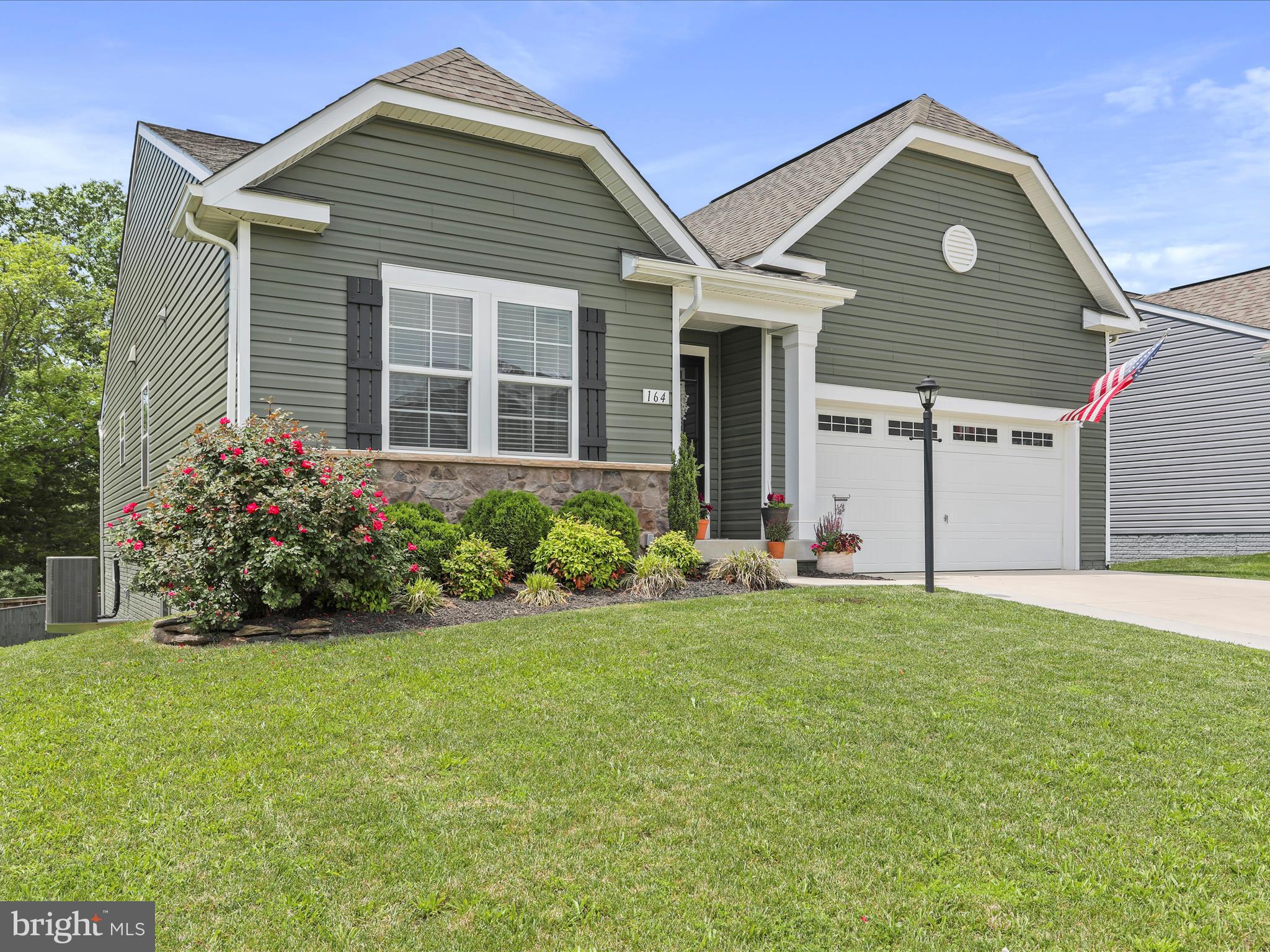 164 Stager Avenue Falling Waters, WV 25419 - Photo 4 of 46 a front view of a house with a yard and garage