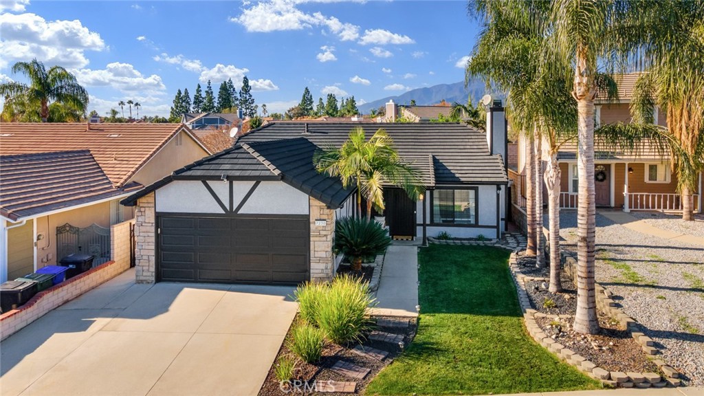 7230 Parkside Place Rancho Cucamonga, CA 91701 - Photo 1 of 1 a front view of a house with garden