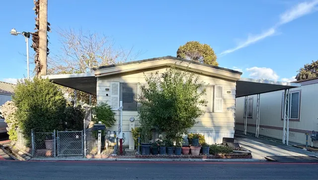 a view of a tall brick building next to a yard