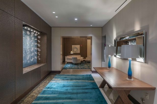 a view of a hallway with wooden floor windows and livingroom