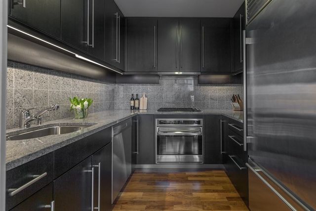a kitchen with a sink and stainless steel appliances