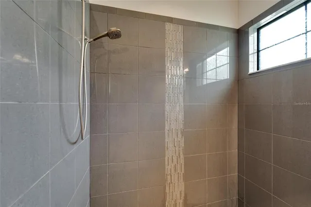 a bathroom with a granite countertop sink a toilet and a mirror