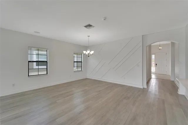 an empty room with a ceiling fan