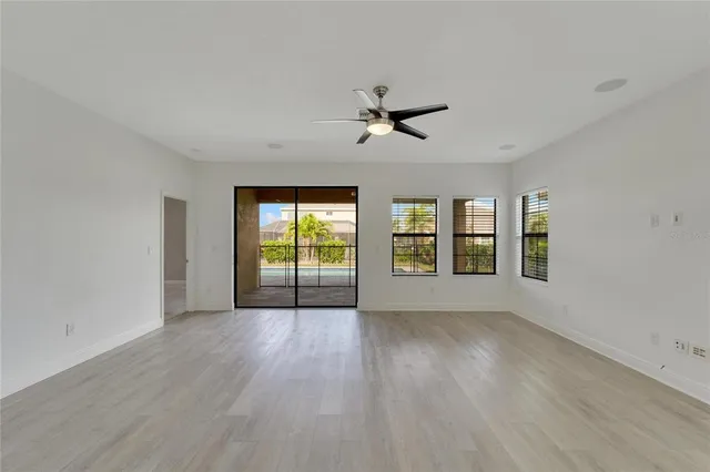 a view of an empty room and a ceiling fan