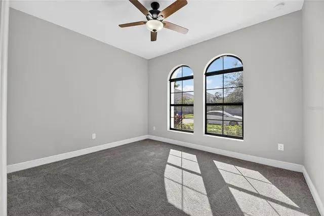 a swimming pool with barbeque oven outdoor seating and trees