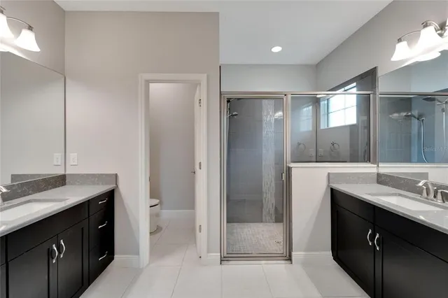 a white toilet sitting next to a white wall