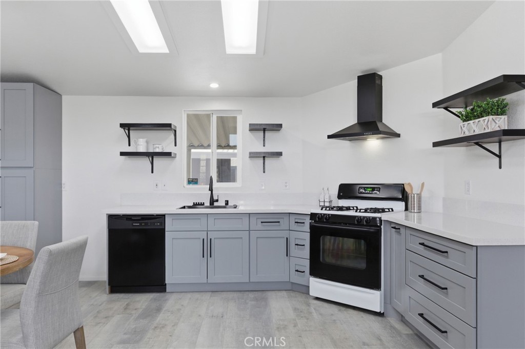 4901 Green River Road, Unit 153 Corona, CA 92878 - Photo 12 of 55 a kitchen with stainless steel appliances a stove a sink and a refrigerator