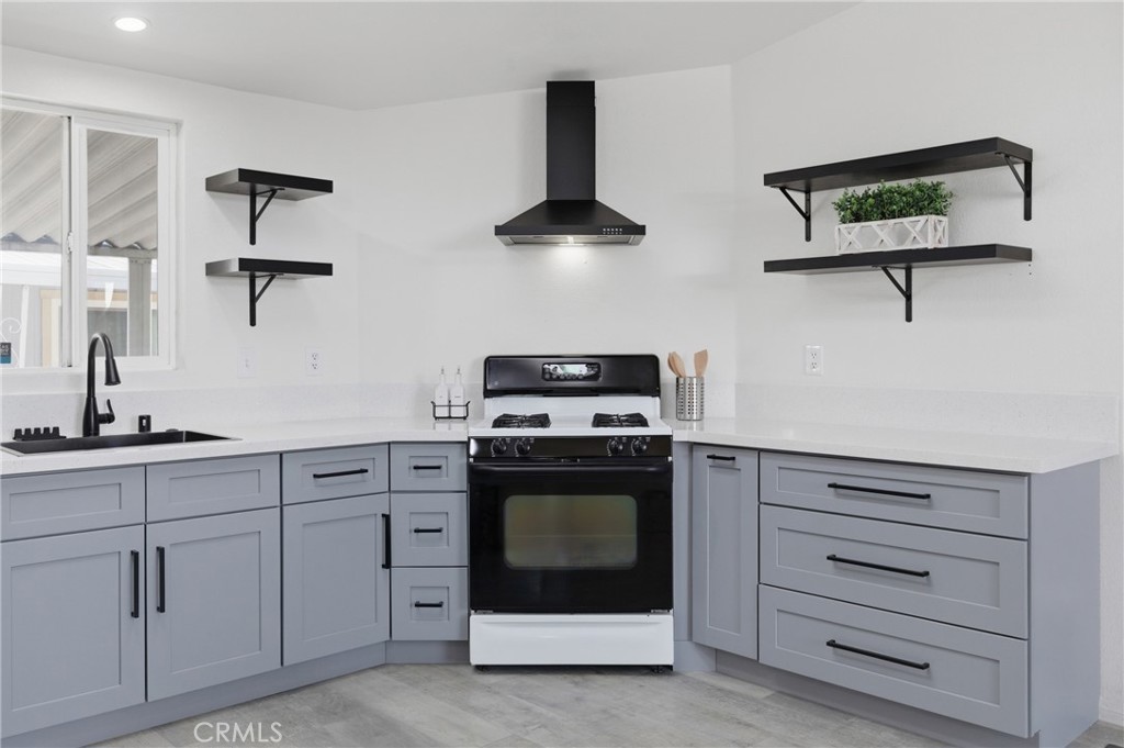 4901 Green River Road, Unit 153 Corona, CA 92878 - Photo 13 of 55 a kitchen with white cabinets and appliances