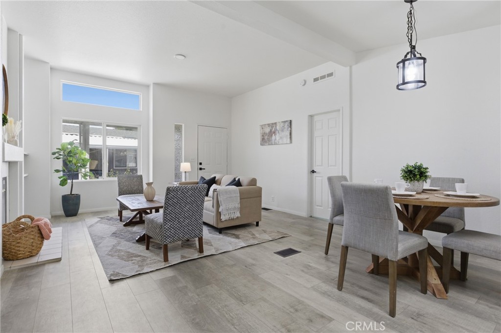 4901 Green River Road, Unit 153 Corona, CA 92878 - Photo 14 of 55 a view of a dining room with furniture window and wooden floor