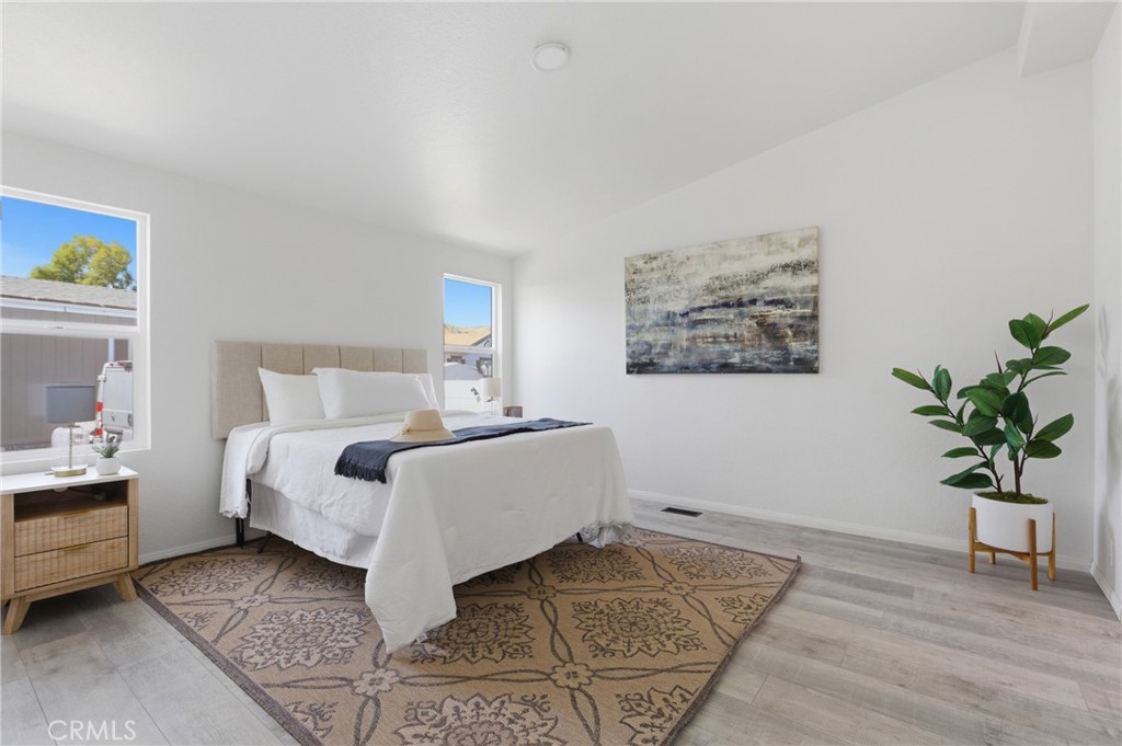 4901 Green River Road, Unit 153 Corona, CA 92878 - Photo 15 of 55 a bedroom with a bed and a potted plant