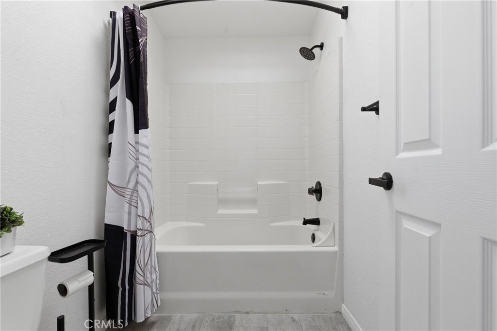 4901 Green River Road, Unit 153 Corona, CA 92878 - Photo 20 of 55 a bathroom with a bathtub and a shower