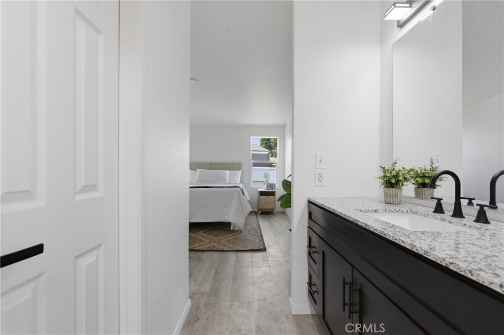 4901 Green River Road, Unit 153 Corona, CA 92878 - Photo 21 of 55 a spacious bathroom with a granite countertop sink and a mirror