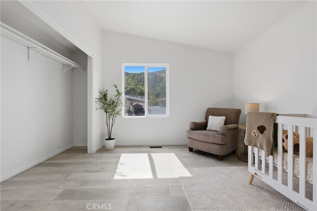 4901 Green River Road, Unit 153 Corona, CA 92878 - Photo 24 of 55 a living room with furniture and a potted plant