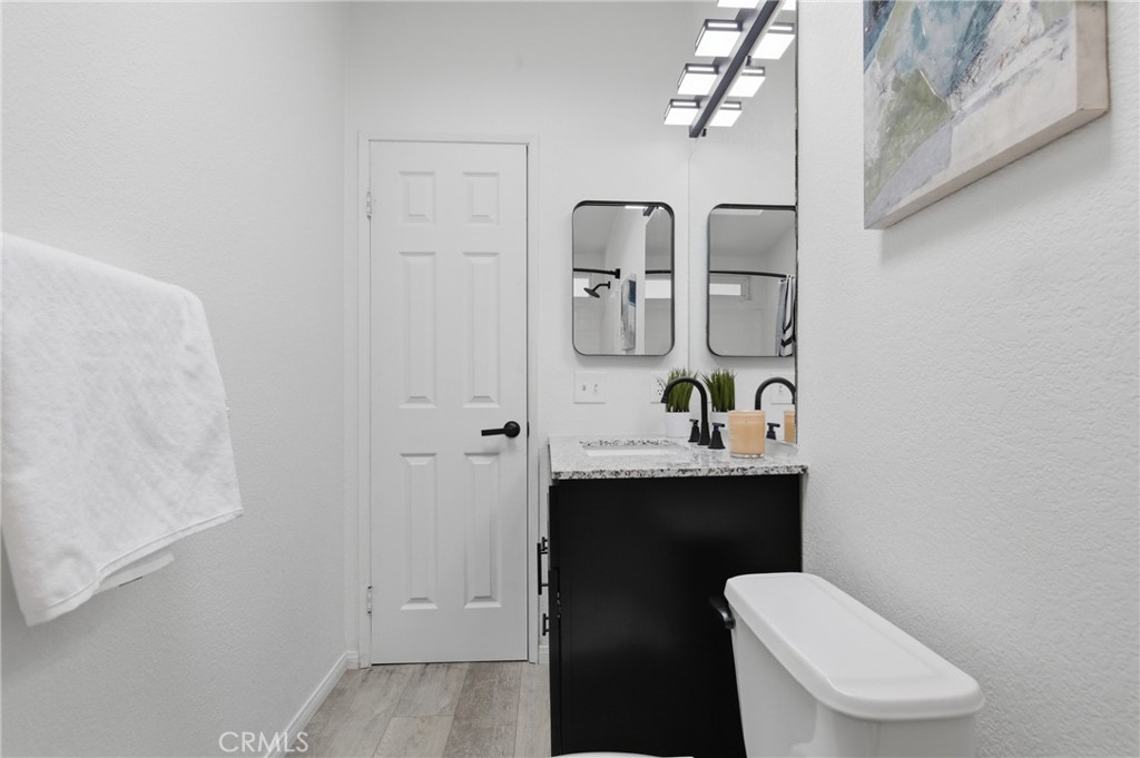 4901 Green River Road, Unit 153 Corona, CA 92878 - Photo 31 of 55 a bathroom with a toilet a sink and mirror