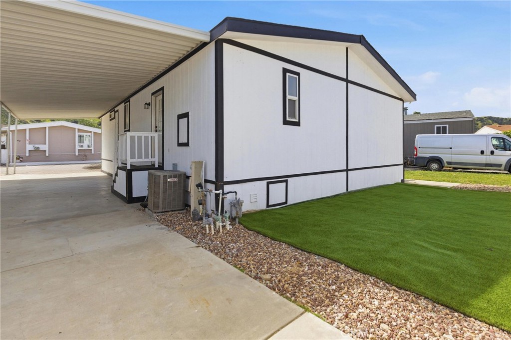 4901 Green River Road, Unit 153 Corona, CA 92878 - Photo 34 of 55 a backyard of a house with barbeque oven table and chairs