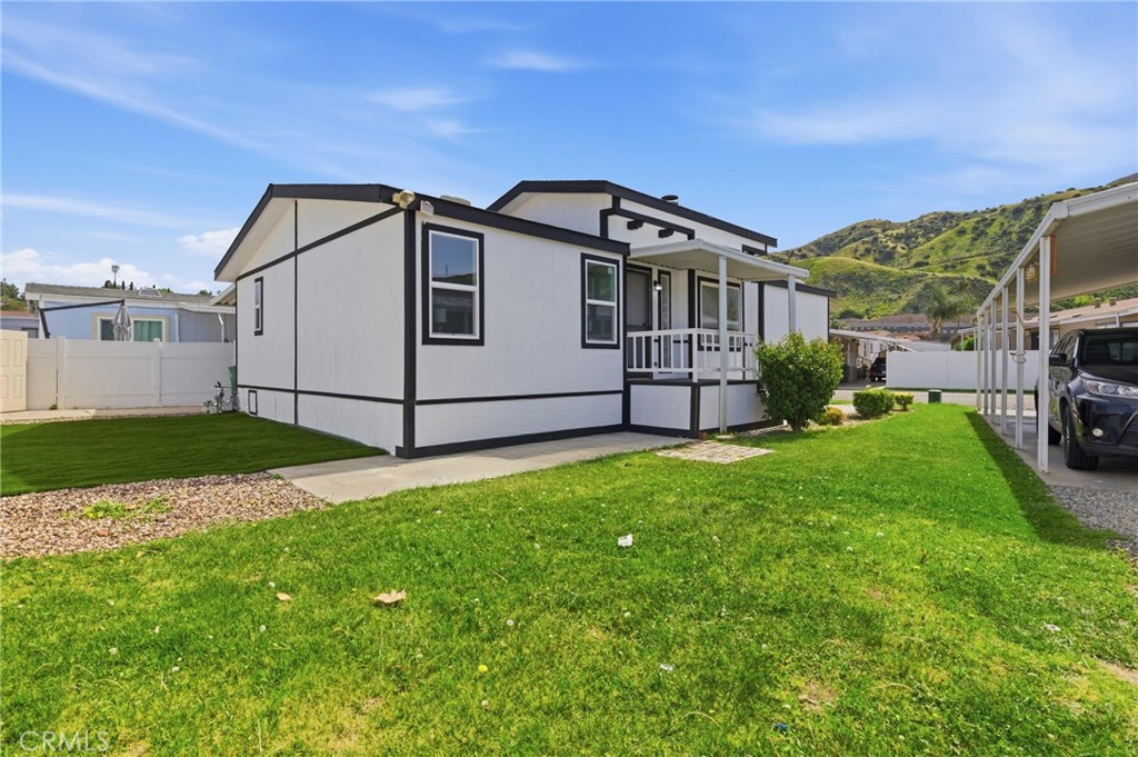 4901 Green River Road, Unit 153 Corona, CA 92878 - Photo 36 of 55 a white house that has tree in front of it