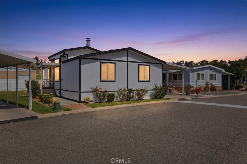 4901 Green River Road, Unit 153 Corona, CA 92878 - Photo 42 of 55 a front view of a house with a yard