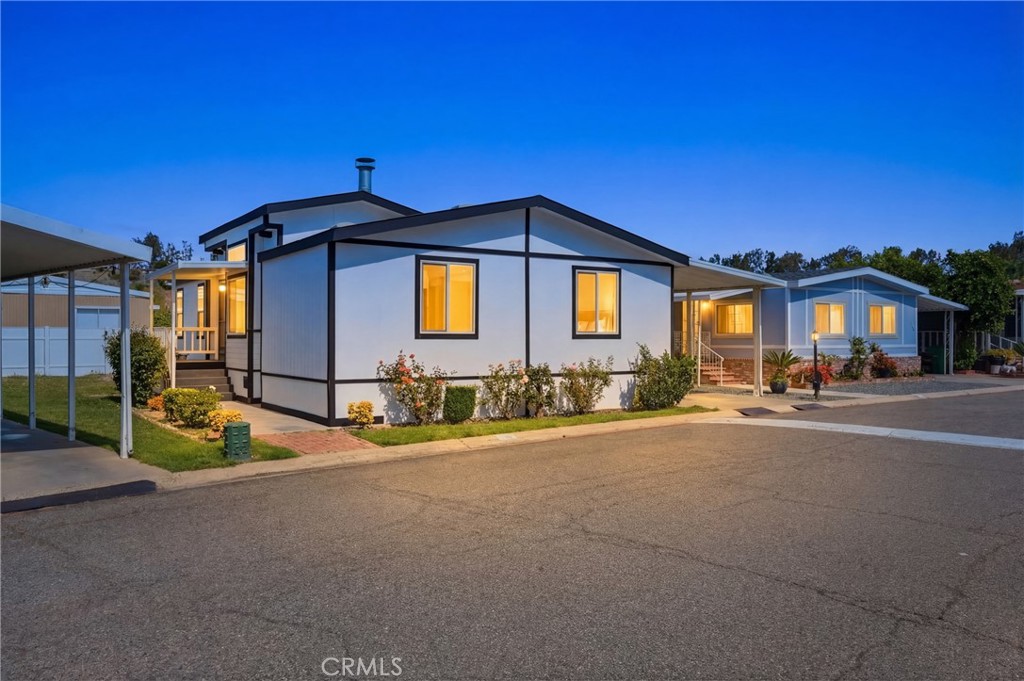 4901 Green River Road, Unit 153 Corona, CA 92878 - Photo 43 of 55 a front view of a house with a yard
