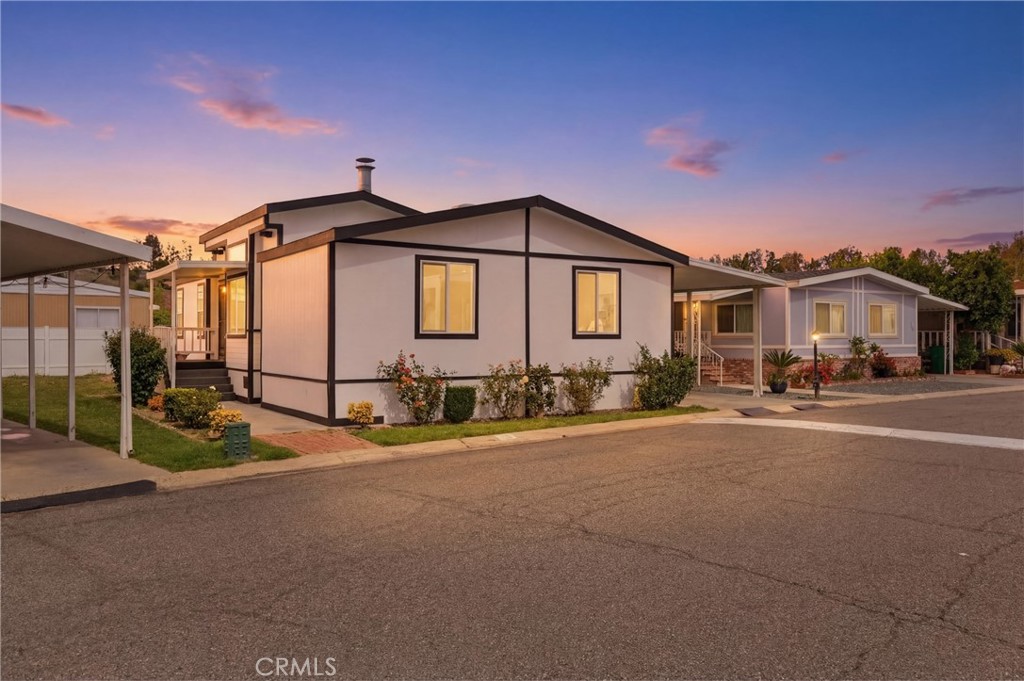 4901 Green River Road, Unit 153 Corona, CA 92878 - Photo 44 of 55 a front view of a house with a yard