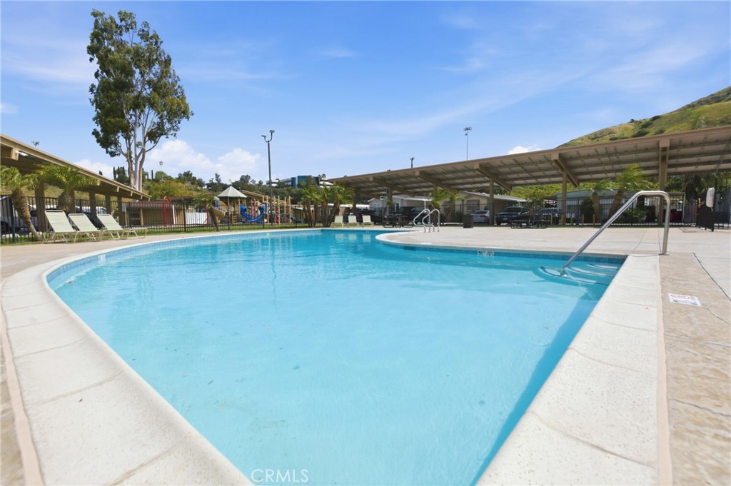 4901 Green River Road, Unit 153 Corona, CA 92878 - Photo 48 of 55 a view of a swimming pool and an outdoor space