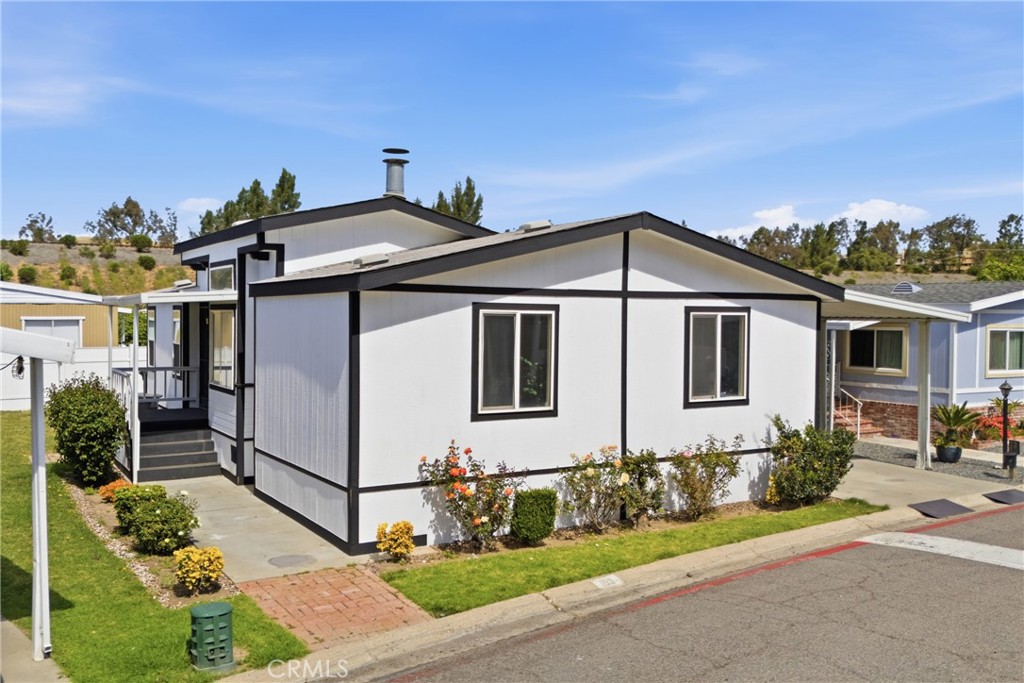 4901 Green River Road, Unit 153 Corona, CA 92878 - Photo 5 of 55 a front view of a house with a yard